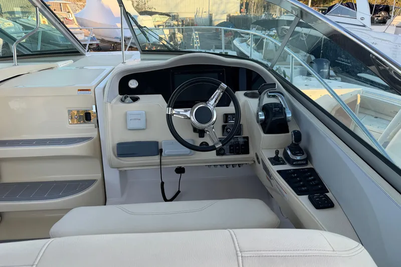  Yacht Photos Pics 2019 Regal 33 OBX boat cockpit with steering wheel and control panel.
