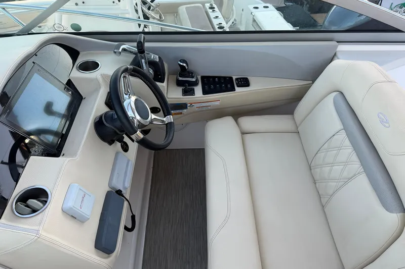  Yacht Photos Pics 2019 Regal 33 OBX boat cockpit with steering wheel and control panel.