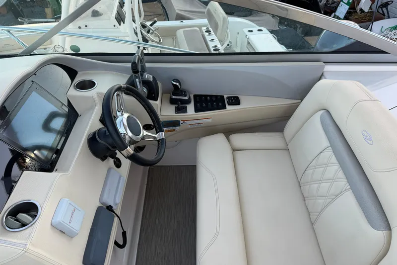 Yacht Photos Pics 2019 Regal 33 OBX boat cockpit with steering wheel and luxurious seating.
