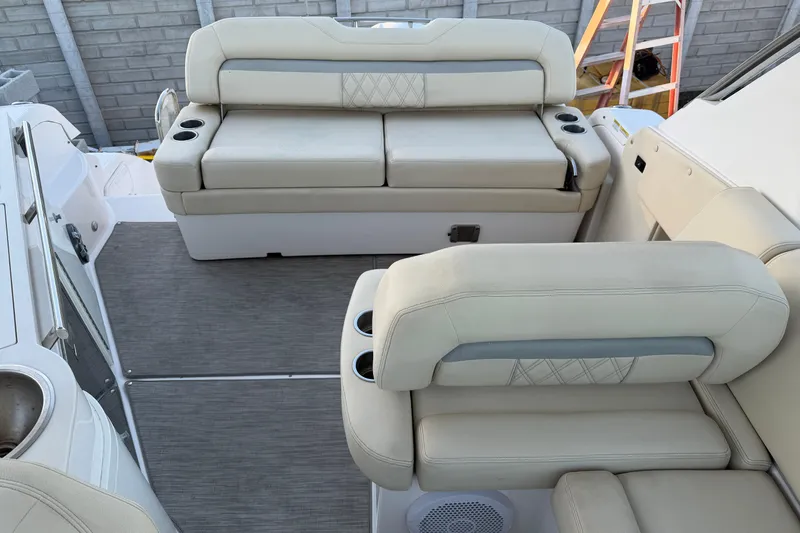  Yacht Photos Pics 2019 Regal 33 OBX boat interior with beige seating and cup holders.