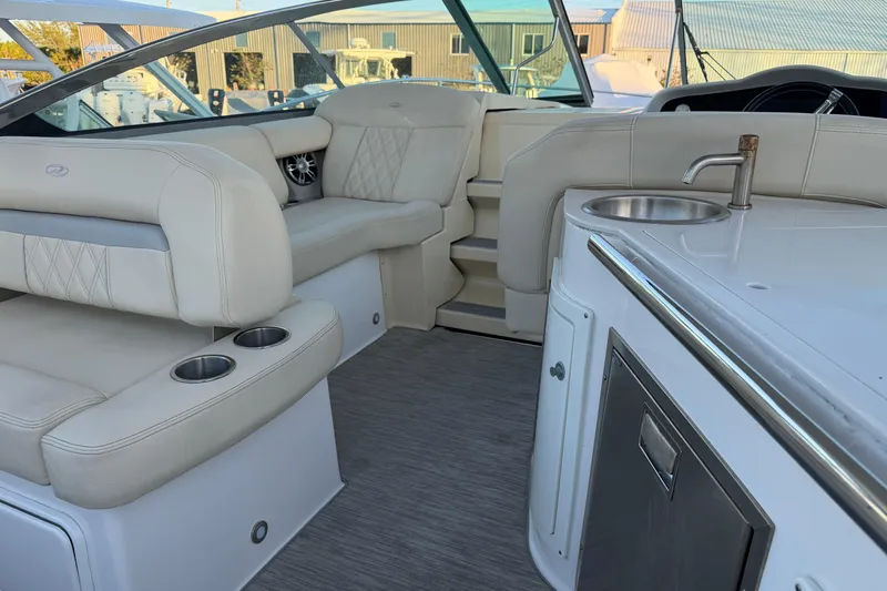  Yacht Photos Pics Luxurious interior of 2019 Regal 33 OBX boat with seating and kitchenette.