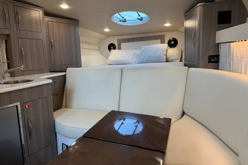  Yacht Photos Pics Luxurious interior of 2019 Regal 33 OBX boat with modern furnishings and cozy seating.