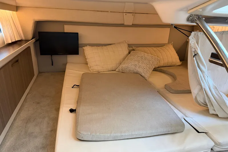  Yacht Photos Pics 2019 Regal 33 OBX cabin interior with cozy bedding and mounted TV.