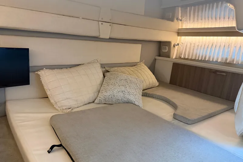  Yacht Photos Pics 2019 Regal 33 OBX cabin interior with cozy bedding and ambient lighting.