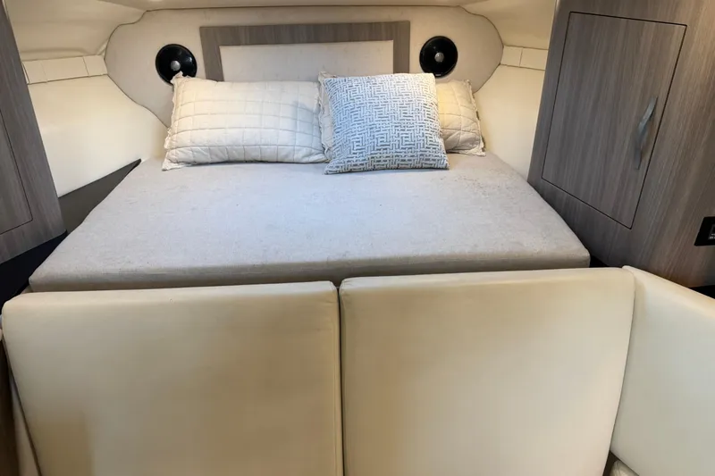  Yacht Photos Pics 2019 Regal 33 OBX cabin interior with cozy bed and pillows.