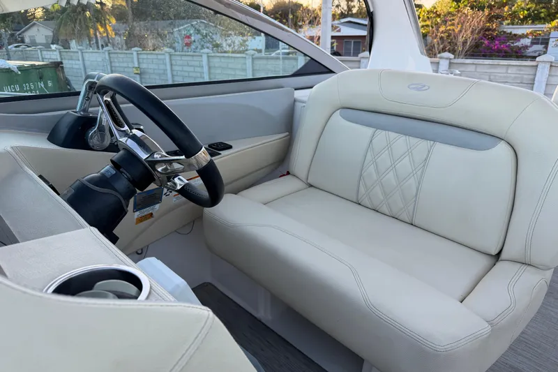  Yacht Photos Pics 2019 Regal 33 OBX boat interior with steering wheel and beige seating.