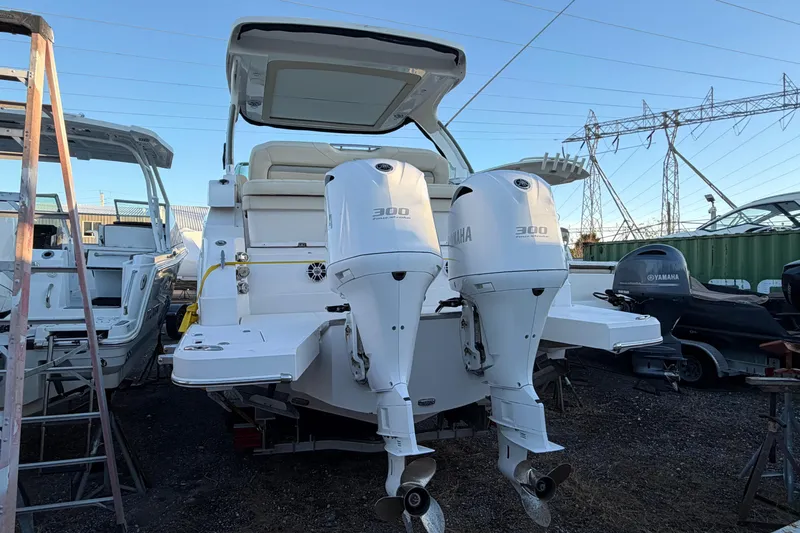  Yacht Photos Pics 2019 Regal 33 OBX boat with twin Yamaha 300 engines, docked outdoors.