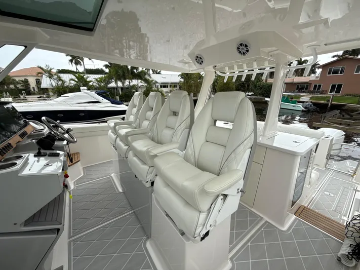  Yacht Photos Pics 2021 Regal 38 SAV boat interior with luxurious white seating and modern dashboard.