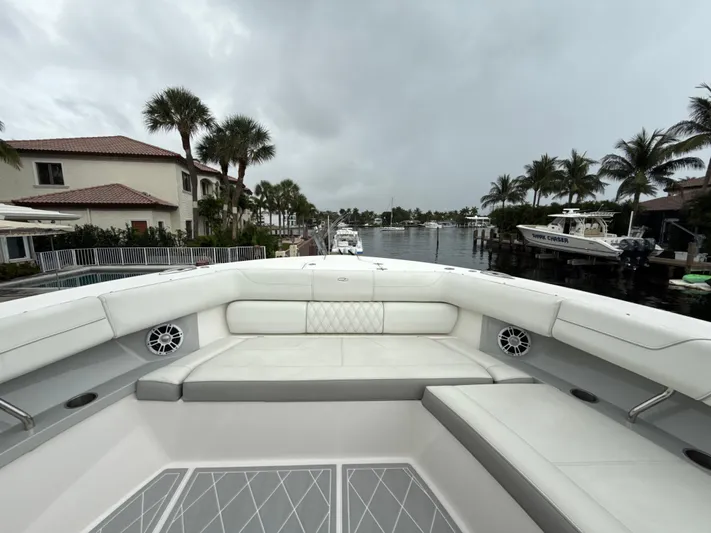  Yacht Photos Pics 2021 Regal 38 SAV boat interior with luxurious seating, docked near waterfront homes.