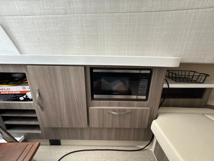  Yacht Photos Pics 2021 Regal 38 SAV interior with microwave, cabinetry, and modern design elements.