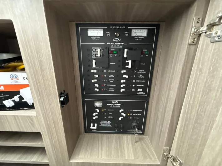  Yacht Photos Pics Electrical control panel on a 2021 Regal 38 SAV boat, featuring various switches and meters.