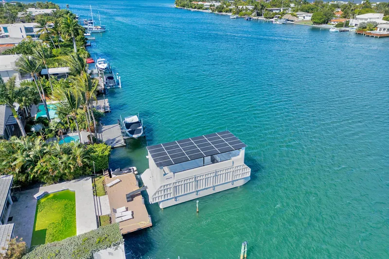  Yacht Photos Pics 2024 ARKUP 50 Liveable Yacht with solar panels on a serene waterfront.