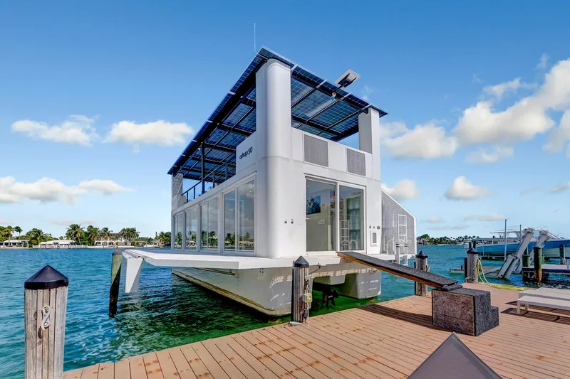  Yacht Photos Pics Modern ARKUP 50 Liveable Yacht, 2024 model, docked on clear blue water under a sunny sky.