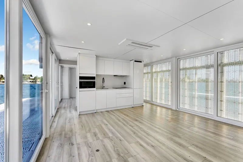  Yacht Photos Pics Modern interior of 2024 ARKUP 50 Liveable Yacht with sleek kitchen and panoramic windows.