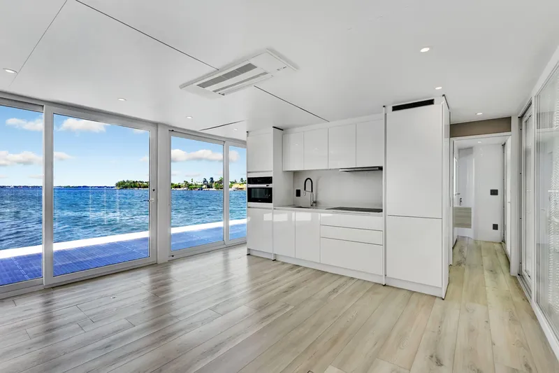  Yacht Photos Pics Modern kitchen interior on ARKUP 50 Liveable Yacht, 2024, with ocean view through large windows.