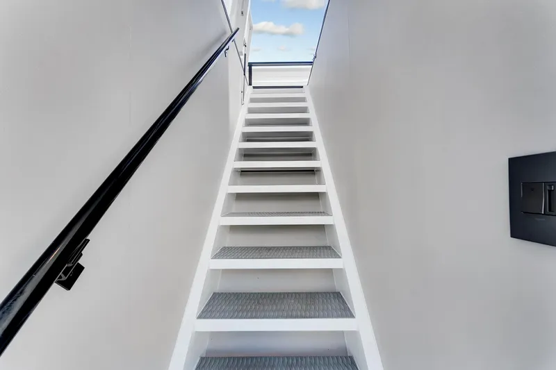  Yacht Photos Pics Staircase on 2024 ARKUP 50 Liveable Yacht, leading to upper deck with sky view.