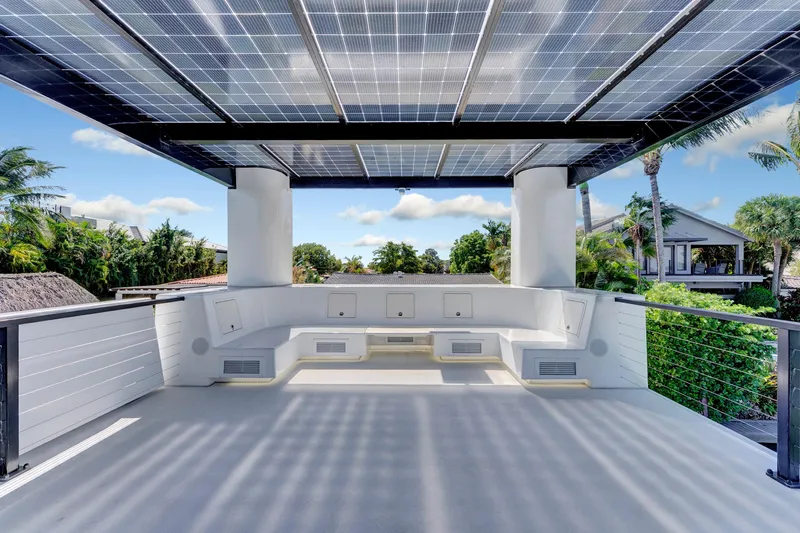  Yacht Photos Pics Rooftop deck of 2024 ARKUP 50 Liveable Yacht with solar panels and seating area.