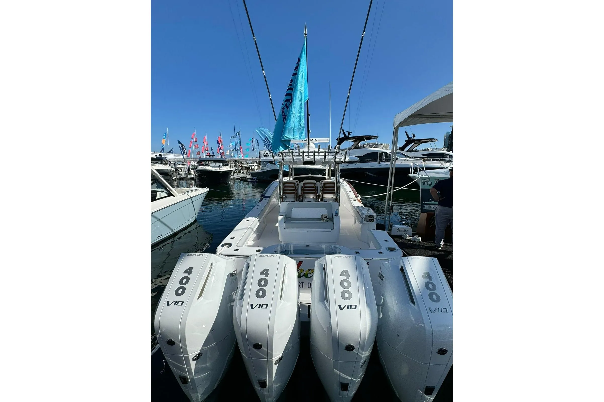2024 Mag Bay 43 CC boat with four Mercury 400 V10 engines at a marina.