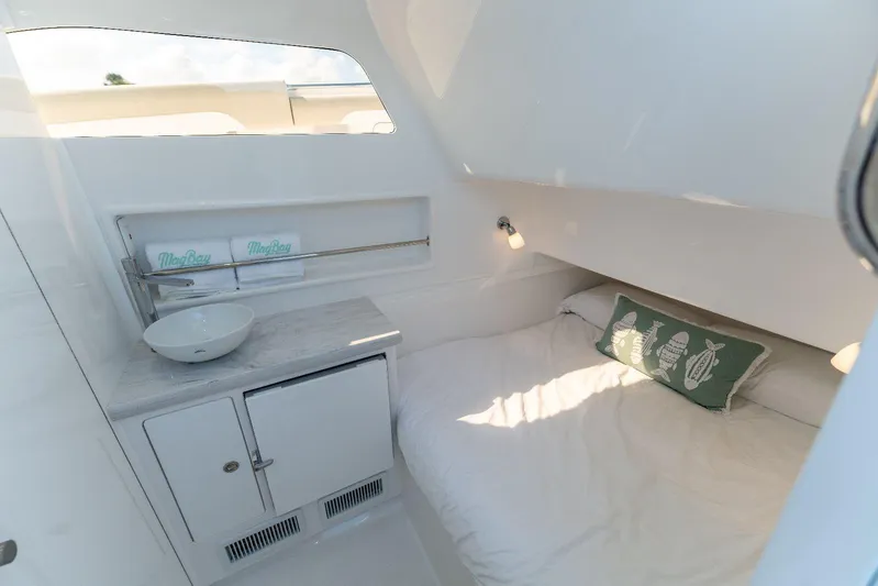  Yacht Photos Pics 2024 Mag Bay 43 CC cabin interior with bed, sink, and decorative pillows.
