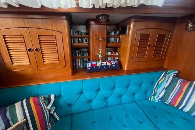 September Morn Yacht Photos Pics Interior of 1986 Little Harbor AFt Cockpit K/CB Sloop with wooden cabinets and blue seating.