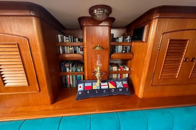 September Morn Yacht Photos Pics Wooden interior of 1986 Little Harbor AFt Cockpit K/CB Sloop with books and nautical decor.