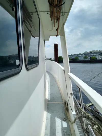 Elizabeth Yacht Photos Pics Side view of 1989 DeFever 57 POC Motor Yacht on a calm river.