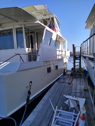 Elizabeth Yacht Photos Pics 1989 DeFever 57 POC Motor Yacht docked, with visible deck and windows.