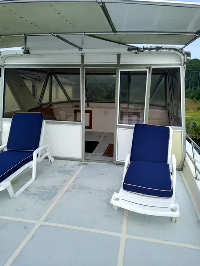 Elizabeth Yacht Photos Pics 1989 DeFever 57 POC Motor Yacht deck with blue cushioned lounge chairs.