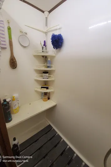 Elizabeth Yacht Photos Pics Shower area in 1989 DeFever 57 POC Motor Yacht with corner shelves and toiletries.