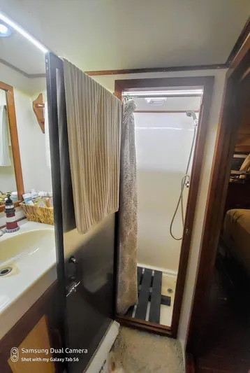 Elizabeth Yacht Photos Pics Bathroom interior of 1989 DeFever 57 POC Motor Yacht with shower and sink.