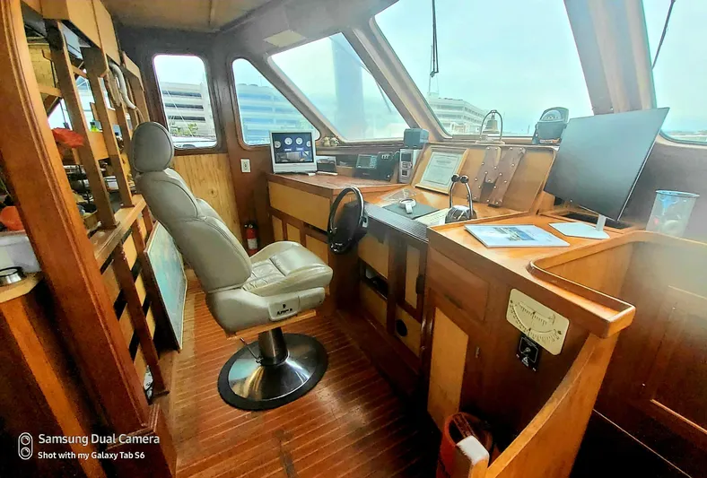 Elizabeth Yacht Photos Pics 1989 DeFever 57 POC Motor Yacht helm with modern navigation equipment and comfortable captain's chair.