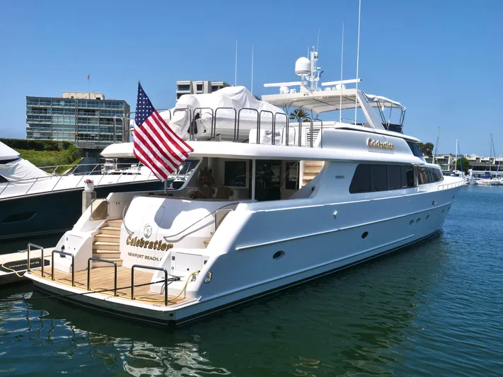 Cwelebration Yacht Photos Pics Luxury 2000 Westport 112 yacht docked, featuring American flag and elegant design.