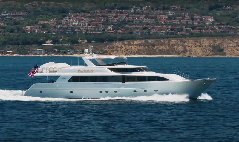 Cwelebration Yacht Photos Pics Luxurious 2000 Westport 112 yacht cruising near scenic coastline with hillside homes.