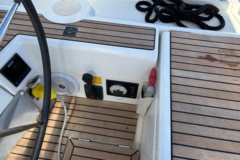  Yacht Photos Pics Cockpit of 2019 Beneteau Oceanis 51.1 sailboat with teak flooring and navigation controls.
