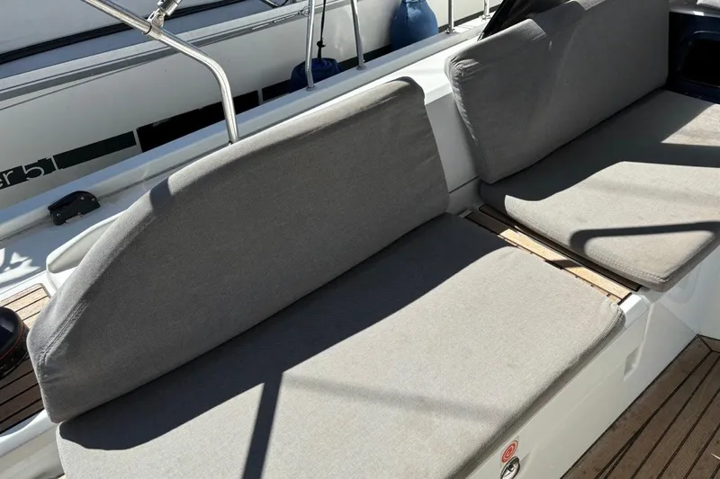  Yacht Photos Pics Beneteau Oceanis 51.1 2019 yacht seating area with gray cushions and wooden deck.
