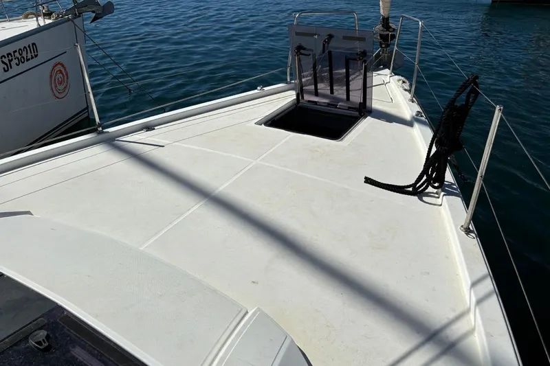  Yacht Photos Pics 2019 Beneteau Oceanis 51.1 yacht deck with open hatch, docked on calm water.