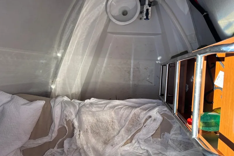  Yacht Photos Pics Interior of 2019 Beneteau Oceanis 51.1 sailboat with bedding and storage shelves.