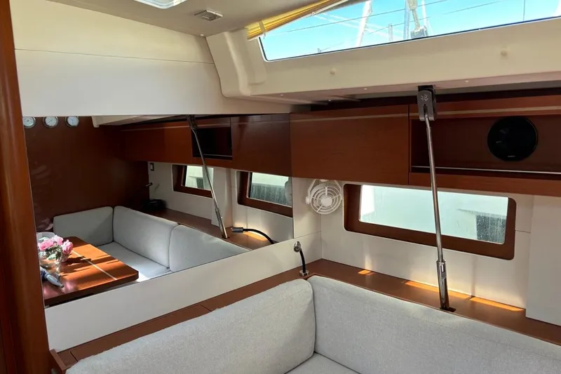  Yacht Photos Pics Interior of 2019 Beneteau Oceanis 51.1 yacht with modern seating and wooden accents.