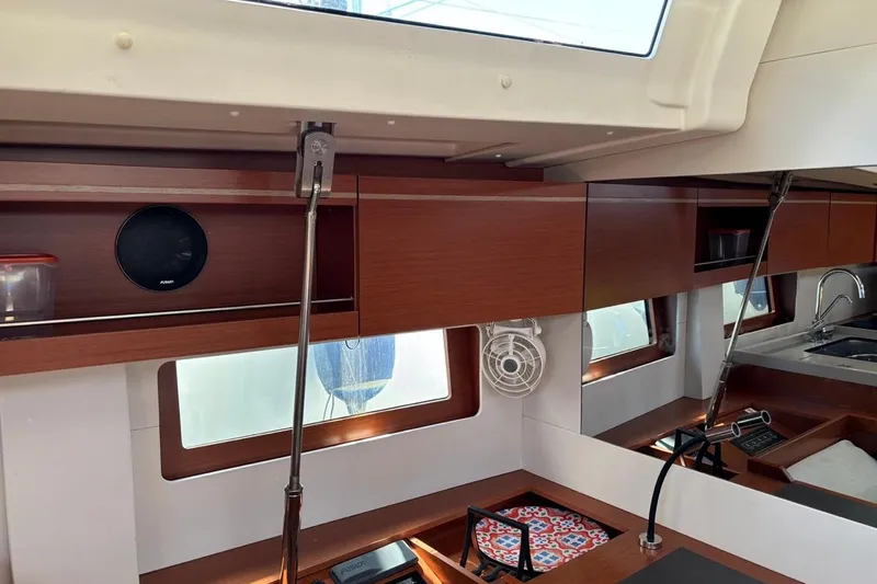  Yacht Photos Pics Interior of 2019 Beneteau Oceanis 51.1 yacht with modern wood cabinetry and sleek design.