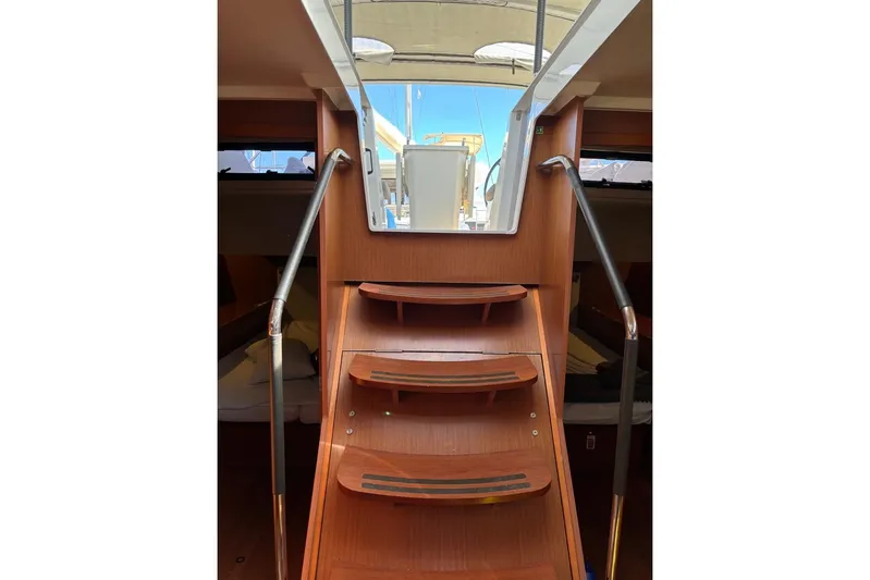  Yacht Photos Pics Interior view of 2019 Beneteau Oceanis 51.1 yacht with wooden stairs and handrails.