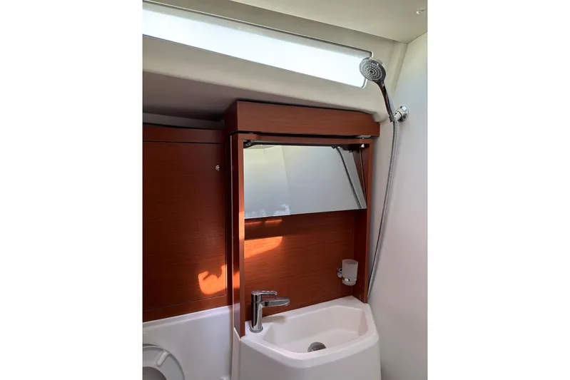  Yacht Photos Pics 2019 Beneteau Oceanis 51.1 bathroom with wooden cabinetry and modern fixtures.