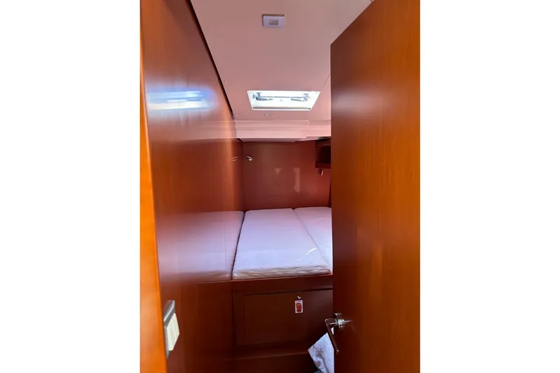  Yacht Photos Pics Interior cabin of 2019 Beneteau Oceanis 51.1 yacht with wooden finish and skylight.