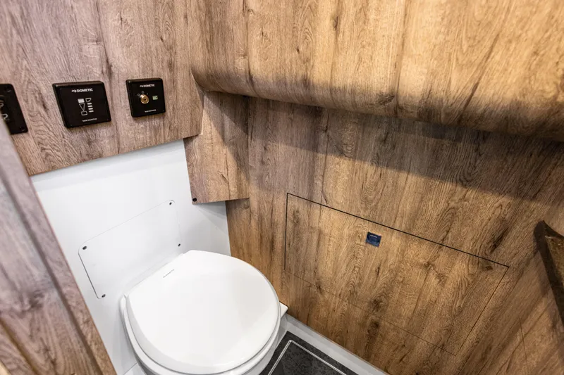  Yacht Photos Pics Luxurious wooden interior of 2026 Mystic Powerboats M4200 bathroom with modern fixtures.