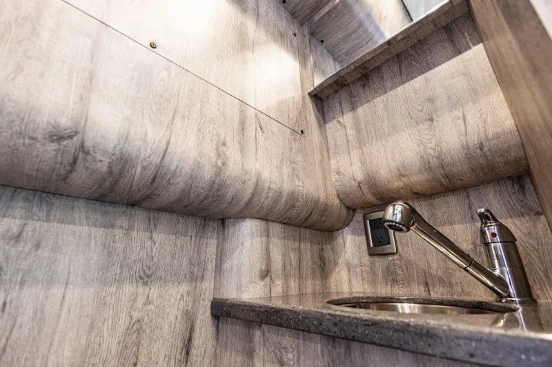  Yacht Photos Pics Interior of 2026 Mystic Powerboats M4200, featuring a sleek sink and modern wood finish.