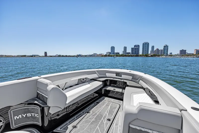  Yacht Photos Pics 2026 Mystic Powerboats M4200 on water with city skyline in background.