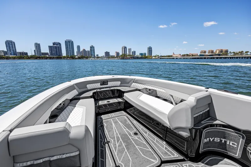  Yacht Photos Pics 2026 Mystic Powerboats M4200 on water with city skyline in background.