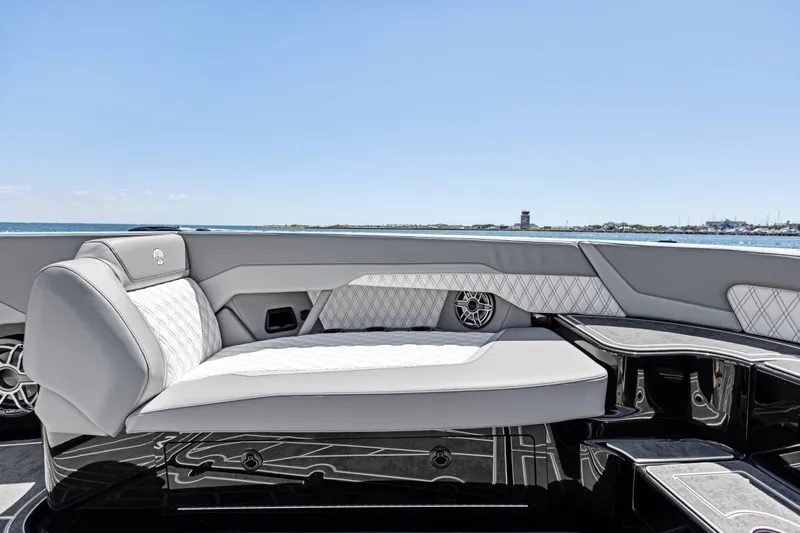  Yacht Photos Pics Luxurious seating on 2026 Mystic Powerboats M4200, featuring elegant design and ocean backdrop.