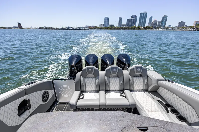  Yacht Photos Pics 2026 Mystic Powerboats M4200 cruising with city skyline in background.