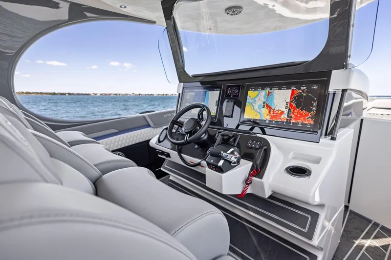  Yacht Photos Pics 2026 Mystic Powerboats M4200 cockpit with advanced navigation displays and luxurious seating.