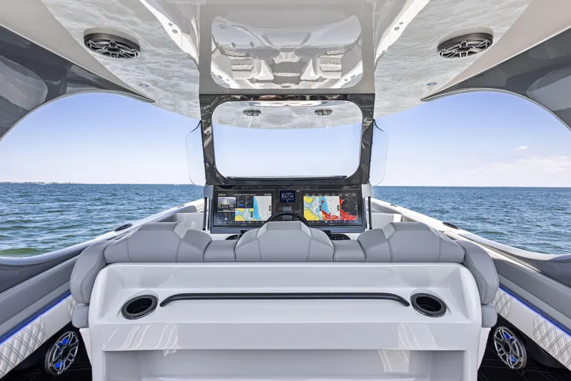  Yacht Photos Pics Interior view of 2026 Mystic Powerboats M4200, featuring advanced navigation screens and luxurious seating.